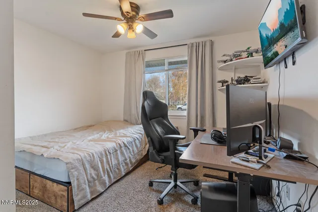 a bedroom with a bed and a desk