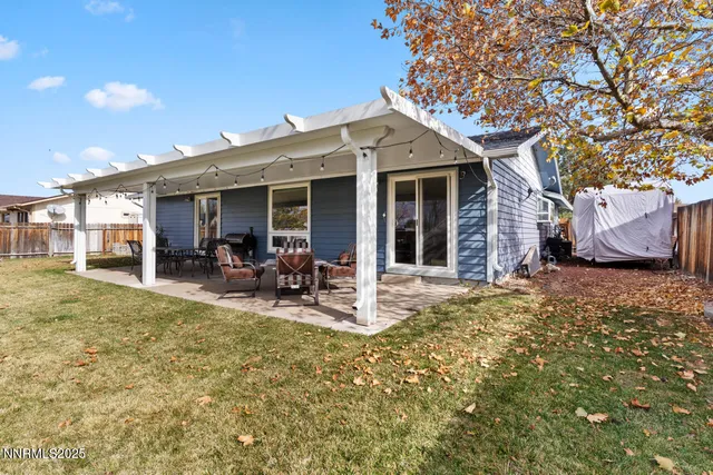 a view of a house with backyard porch and sitting area