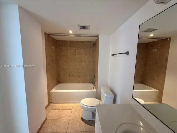 a bathroom with a toilet and a bathtub