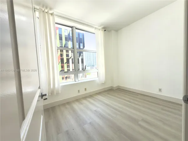 a view of an empty room with a window