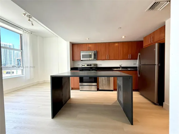 a kitchen with stainless steel appliances a refrigerator and a stove