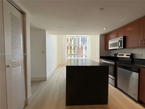 a kitchen with a sink and a stove top oven