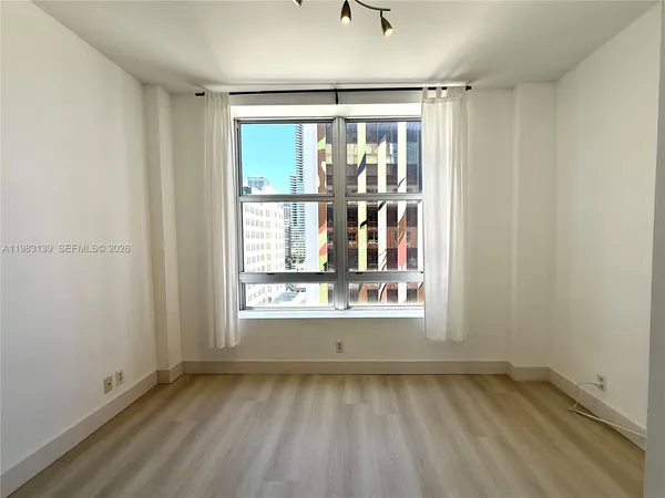 a view of an empty room and a window