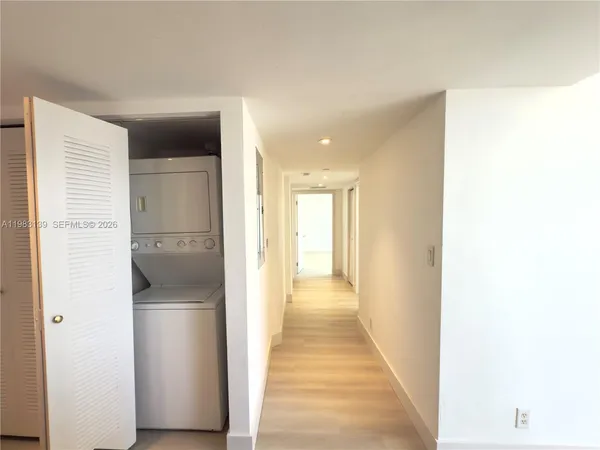 a view of a hallway with a wooden cabinets