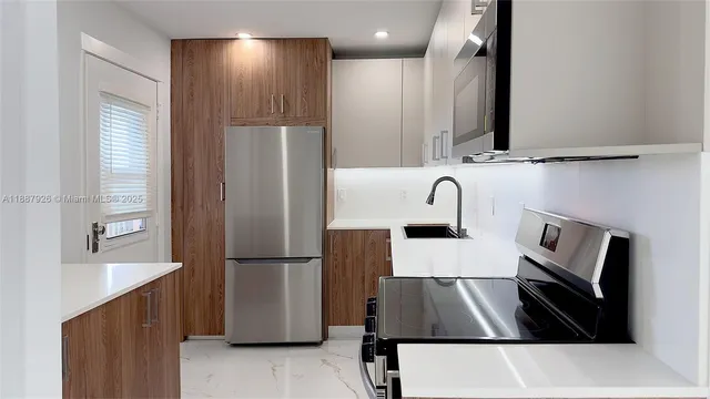 a kitchen with refrigerator and sink