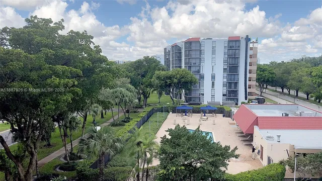 a view of a patio with couches table and chairs and potted plants