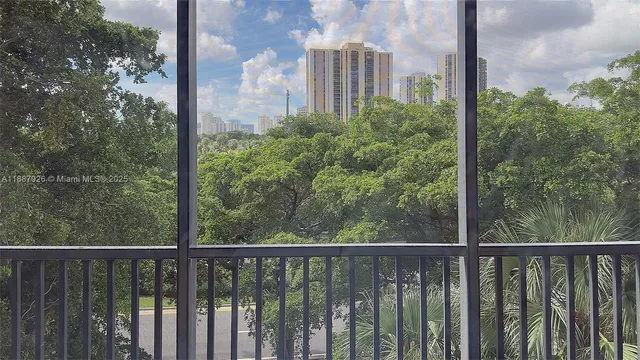 a view of a balcony with yard