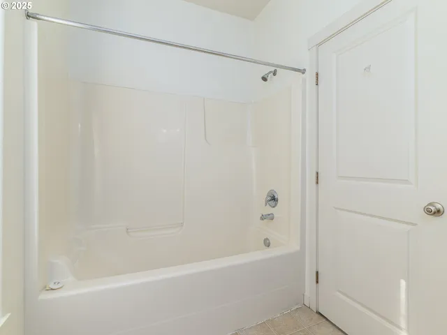 a bathroom with a shower and a bath tub