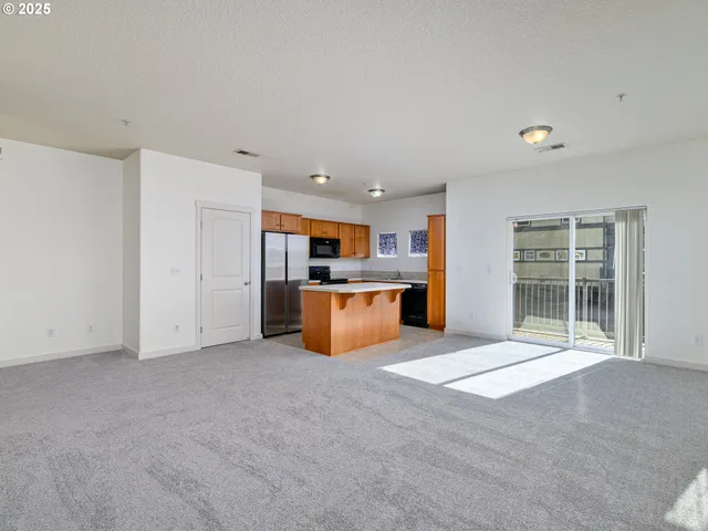 a view of kitchen with stainless steel appliances a refrigerator and a sink