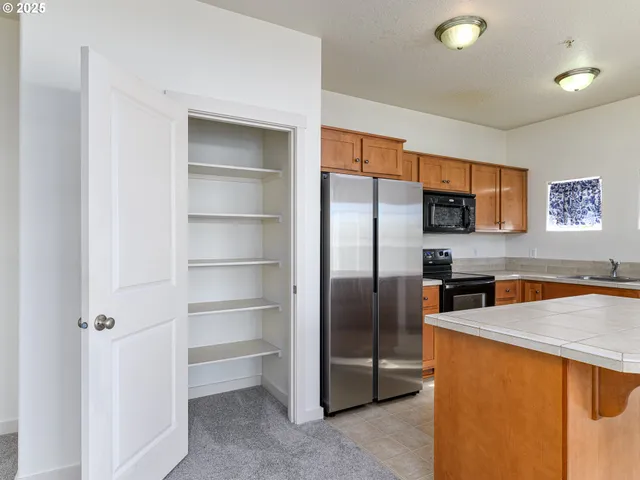 a kitchen with stainless steel appliances a refrigerator and a sink