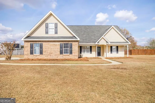 a front view of a house with a garden