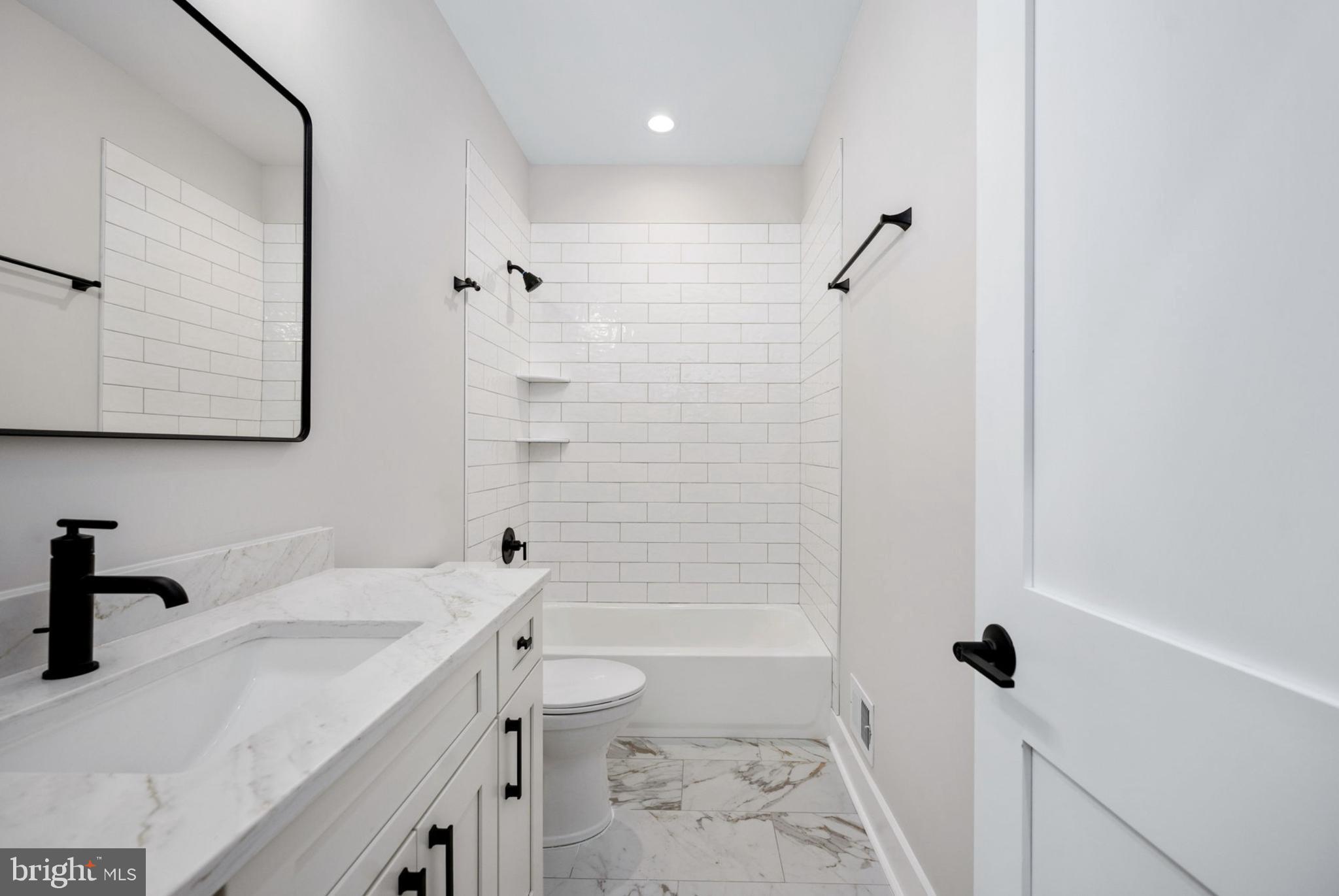 75 Sleepy Hollow Road Linden, VA 22642 - Photo 11 of 19 a bathroom with a granite countertop sink a toilet and shower