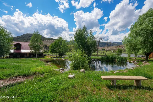 a view of a lake with a house in the background