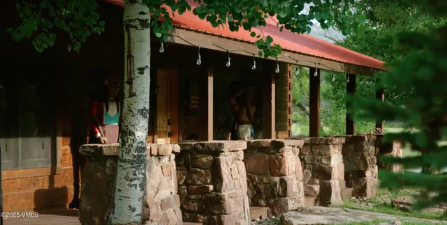 a living room with furniture fireplace and wooden floor