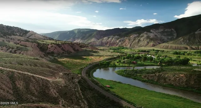 a view of a lush green hillside and a building