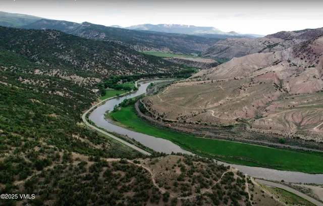 a view of a house with a mountain and a forest