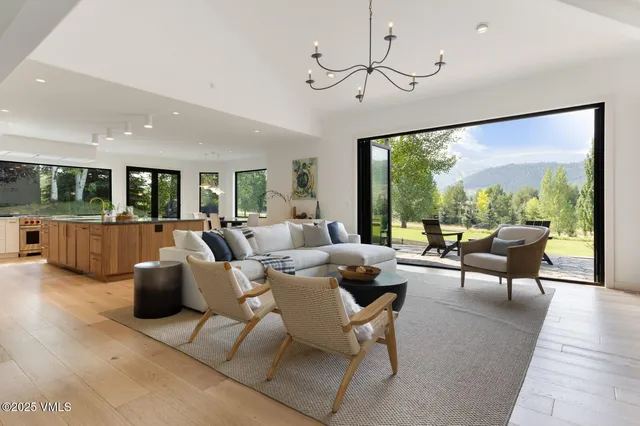 a living room with furniture large window and flat screen tv