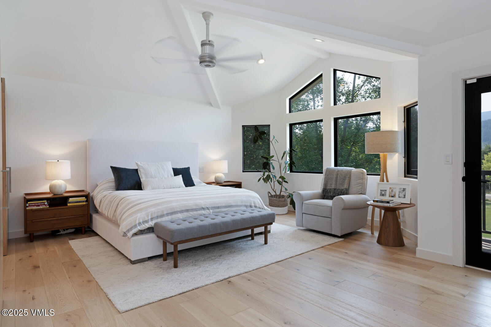 161 Stagecoach Road Edwards, CO 81632 - Photo 11 of 48 a spacious bedroom with a bed a couch and a large window