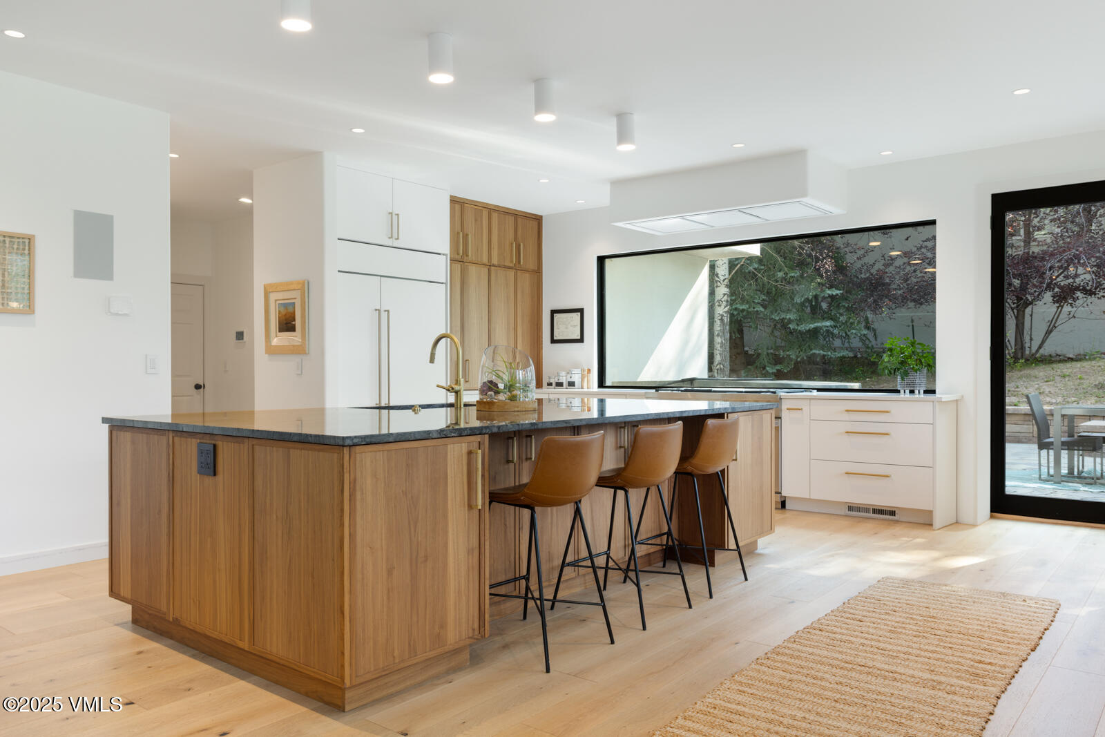 161 Stagecoach Road Edwards, CO 81632 - Photo 7 of 48 a view of a kitchen with kitchen island granite countertop wooden floor and white cabinets