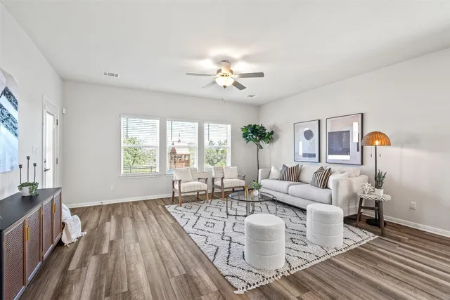 a living room with furniture and wooden floor