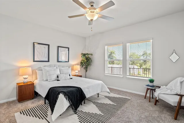 a kitchen with white cabinets stainless steel appliances and dining table