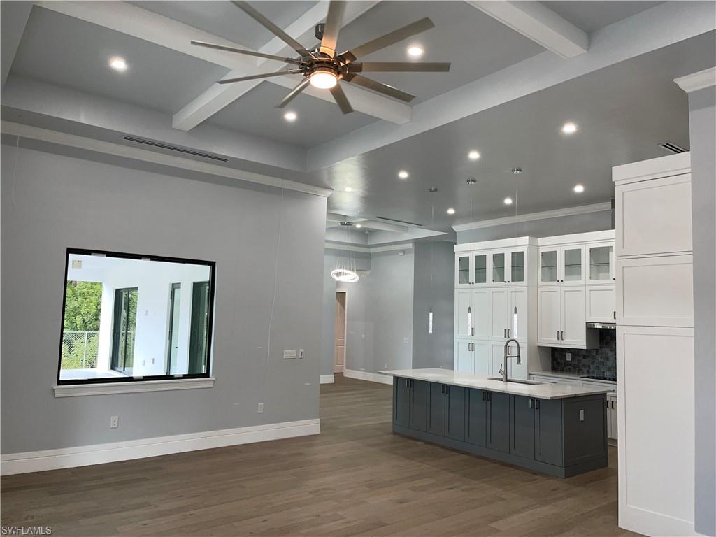 3203 68th Street Southwest Naples, FL 34105 - Photo 12 of 34 a large room with a large window and stainless steel appliances
