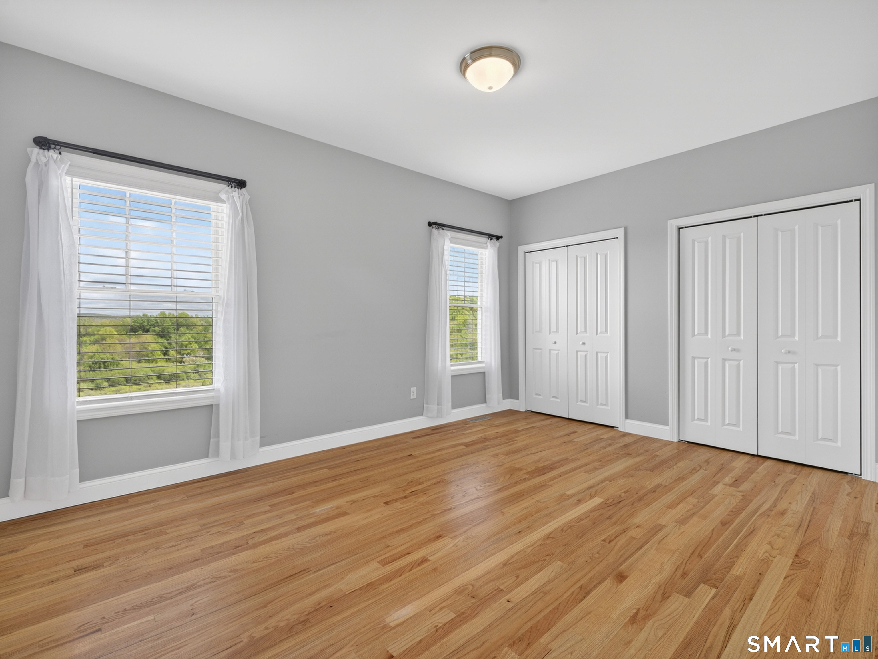 650 Ridgewood Road Middletown, CT 06457 - Photo 18 of 40 a view of an empty room with wooden floor and a window