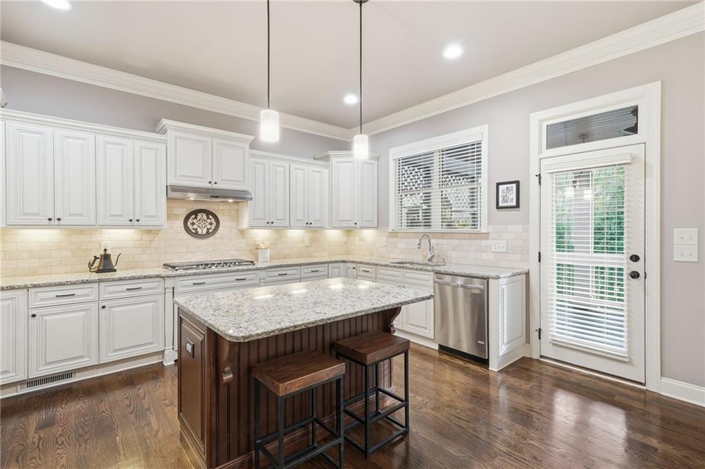 262 Trecastle Square Canton, GA 30114 - Photo 13 of 46 a kitchen with sink cabinets and wooden floor