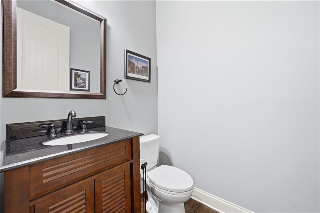 262 Trecastle Square Canton, GA 30114 - Photo 23 of 46 a bathroom with a toilet sink and mirror