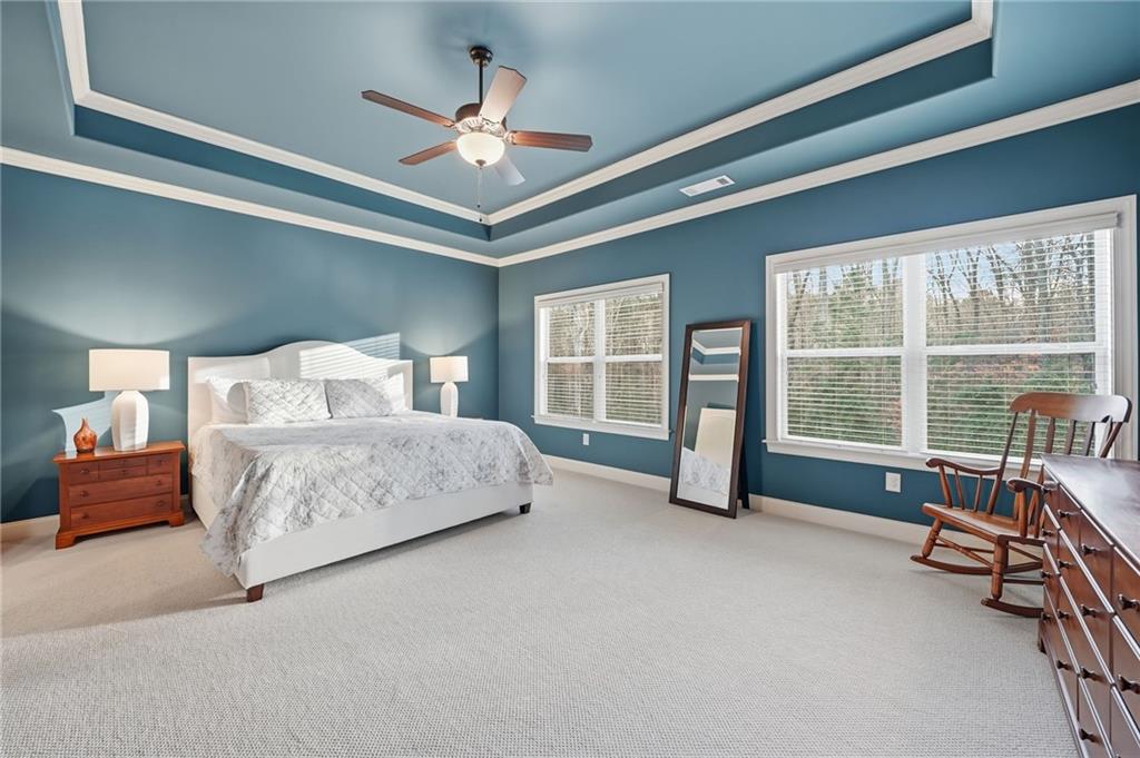 262 Trecastle Square Canton, GA 30114 - Photo 24 of 46 a bedroom with a large bed and a ceiling fan