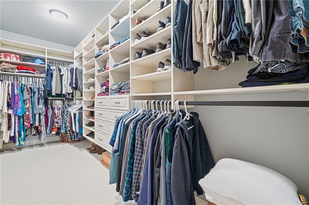 262 Trecastle Square Canton, GA 30114 - Photo 27 of 46 a view of walk in closet with clothes and shoes