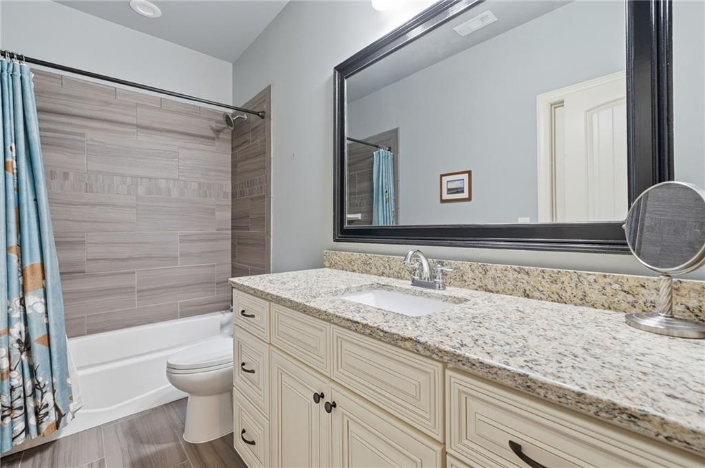 262 Trecastle Square Canton, GA 30114 - Photo 30 of 46 a bathroom with a granite countertop sink toilet and shower