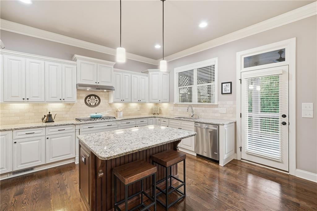 262 Trecastle Square Canton, GA 30114 - Photo 4 of 46 a kitchen with sink cabinets and wooden floor