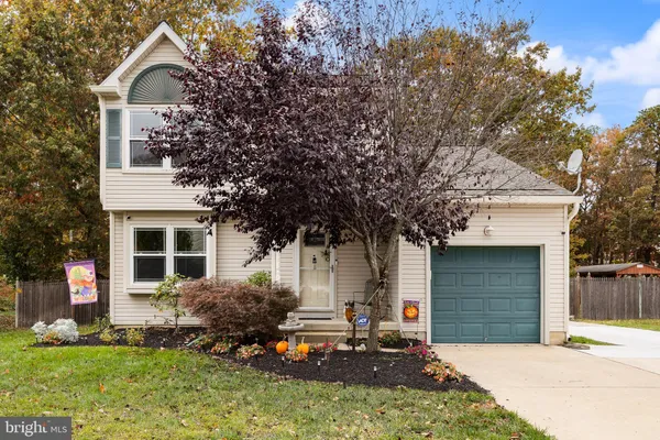 a front view of a house with a yard garage and outdoor seating