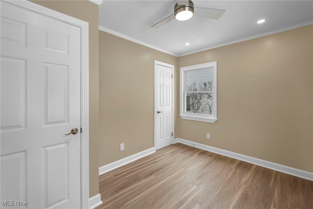 1447 East Sprague Road Independence, OH 44131 - Photo 26 of 47 Unfurnished bedroom with ceiling fan, a closet, ornamental molding, and light hardwood / wood-style flooring