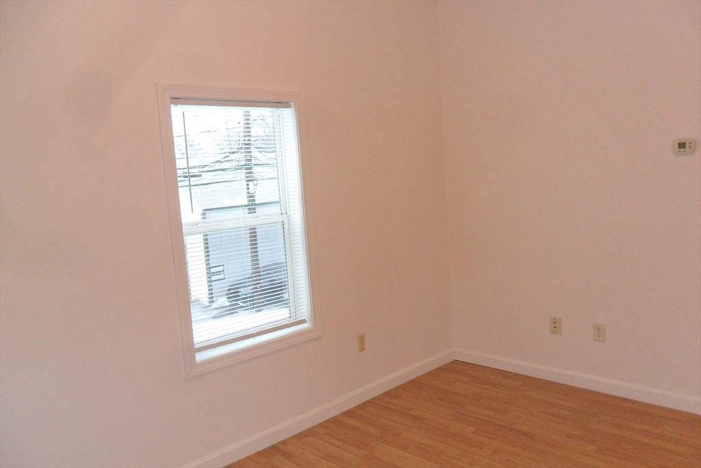 848 Waverly Street, Unit 3 Framingham, MA 01702 - Photo 5 of 8 an empty room with a window