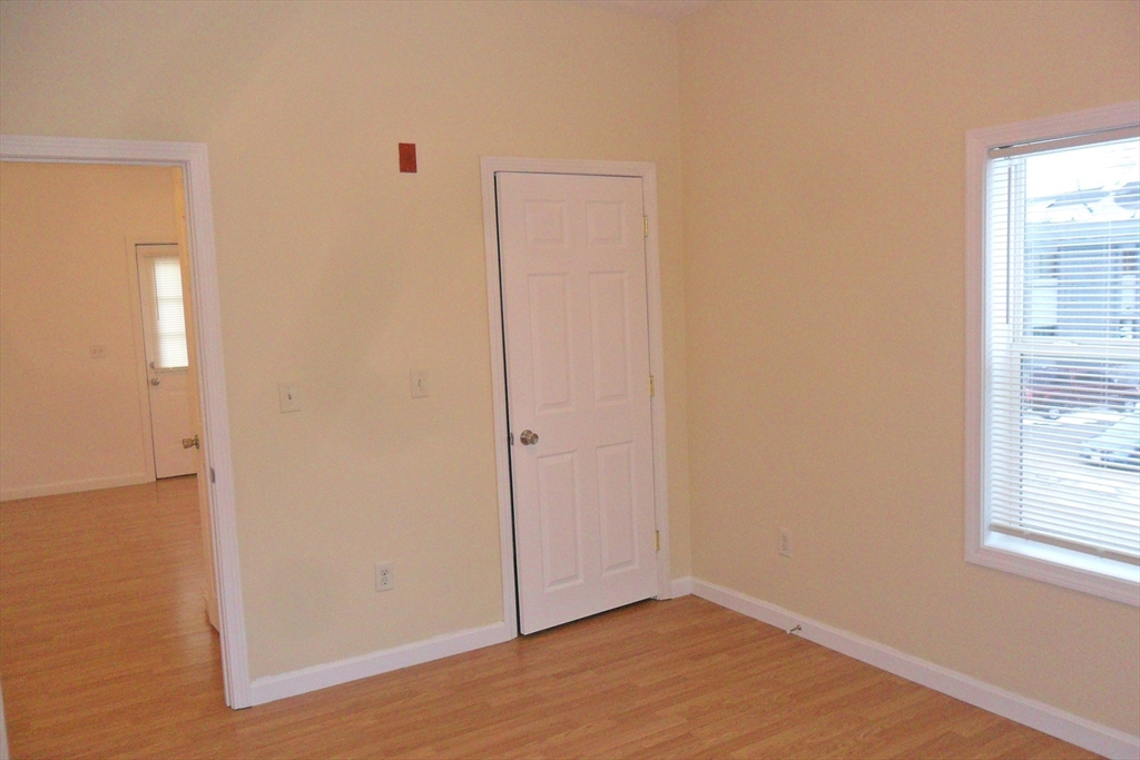 848 Waverly Street, Unit 3 Framingham, MA 01702 - Photo 8 of 8 an empty room with windows and closet