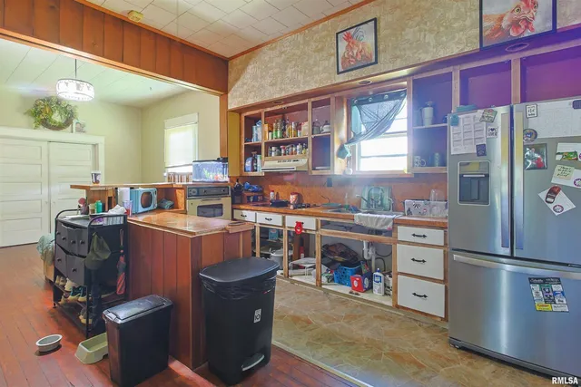 a room with wooden cabinets and stainless steel appliances