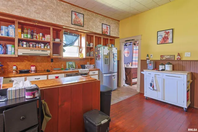 a kitchen with stainless steel appliances granite countertop a refrigerator a stove top oven a sink and dishwasher