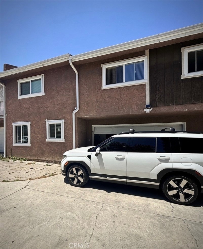 7258 Exeter Street, Unit 6 Paramount, CA 90723 - Photo 16 of 16 a view of parking space with car parked