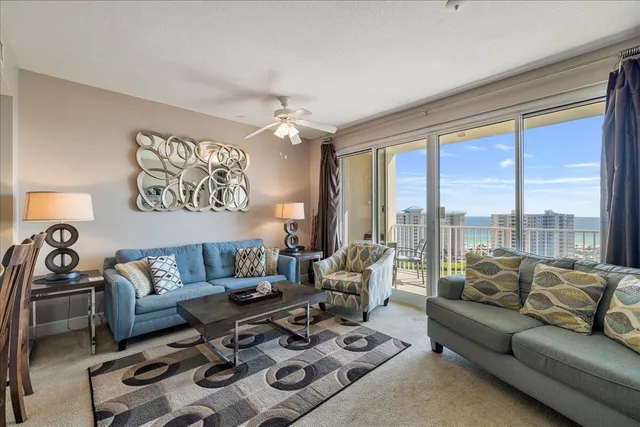 a living room with furniture and large windows