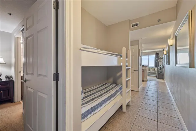 a hallway with white cabinets and a fireplace