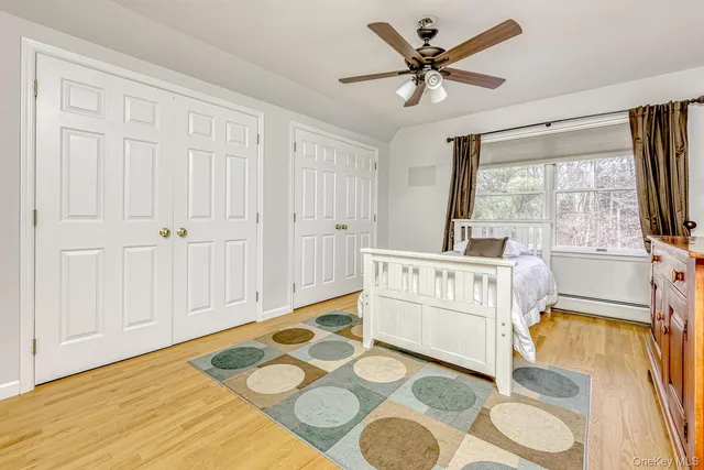 a living room with white furniture and a flat screen tv