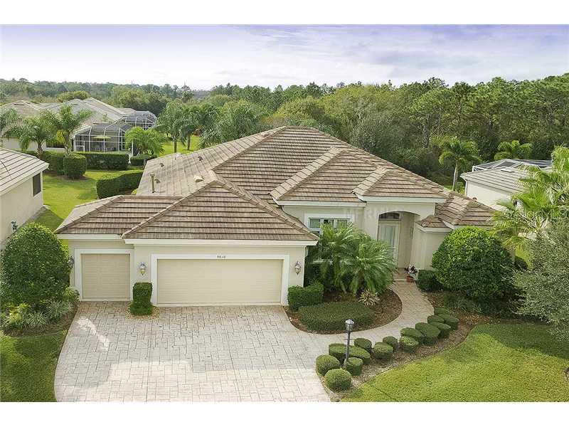 9616 53rd Lakewood Ranch Lakewood Ranch, FL 34211 - Photo 1 of 1 a white house with a yard plants and large tree