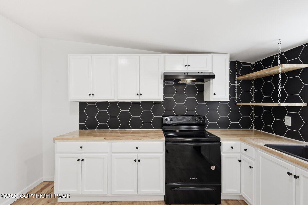 155 Blooming Grove Road Hawley, PA 18428 - Photo 18 of 41 a kitchen with a stove and a cabinets