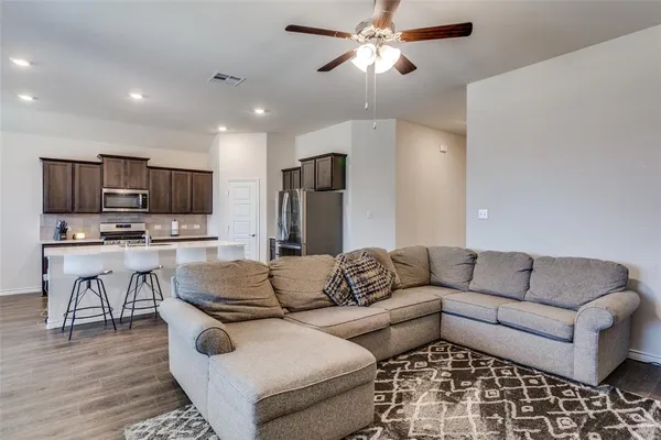 a living room with furniture kitchen and a dining table