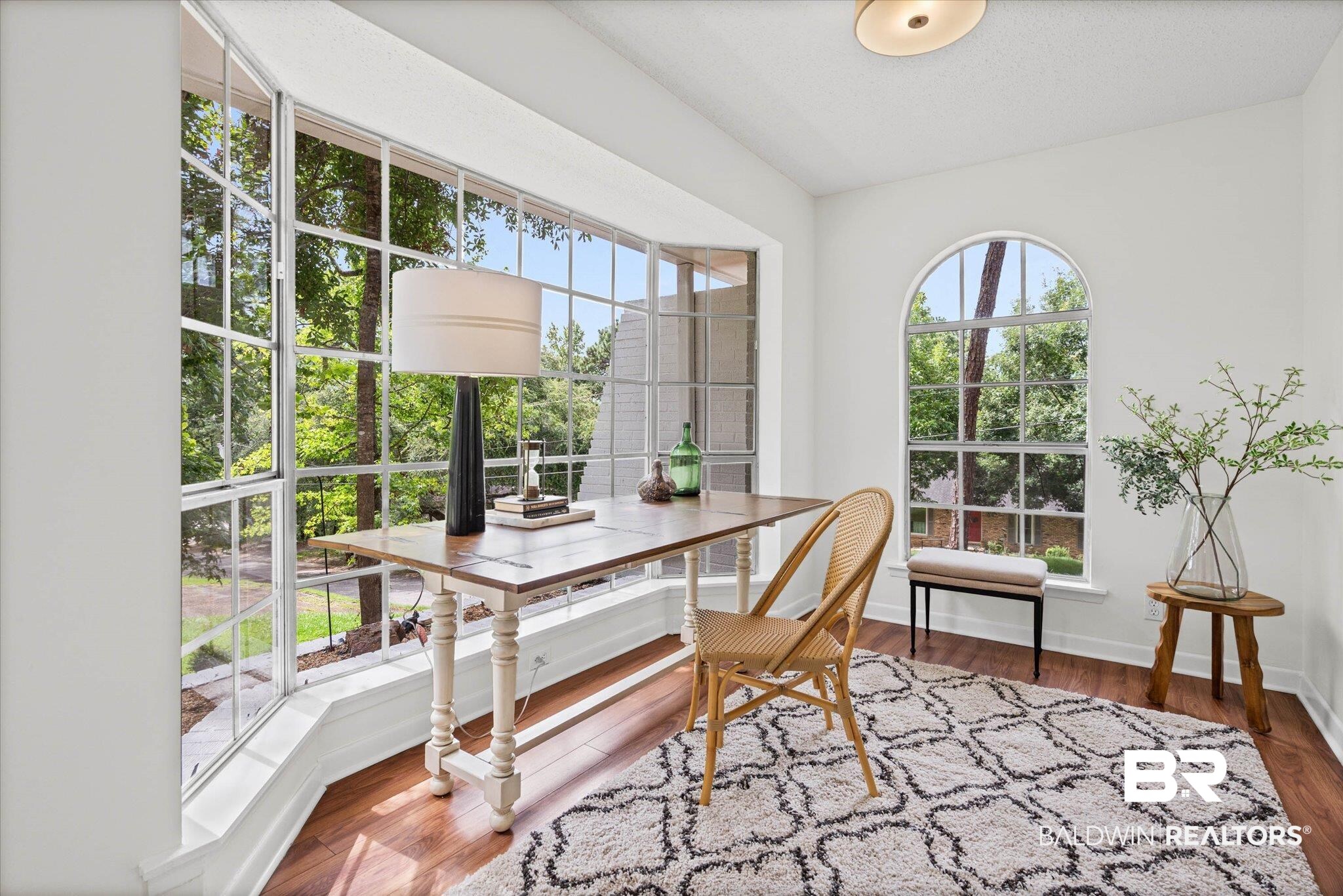 9 Bull Run Road Spanish Fort, AL 36527 - Photo 7 of 23 Bright room featuring a large bay window and an additional arched window, both with mullioned panes