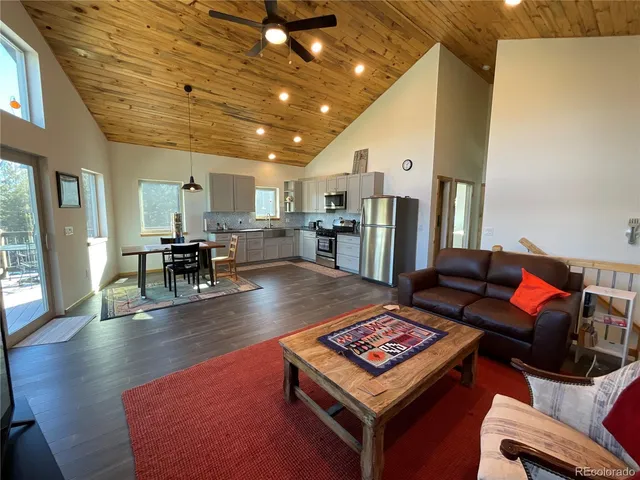 a living room with lots of furniture and kitchen view