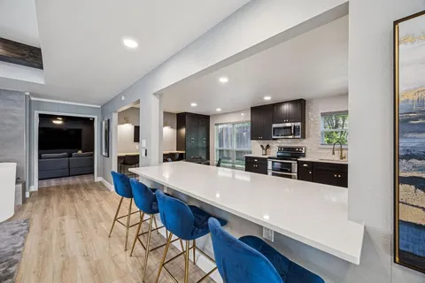 a large kitchen with a table and chairs in it