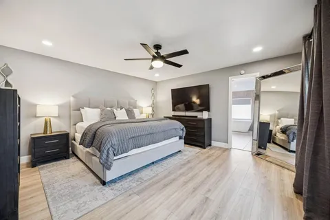 a bedroom with a bed and a flat screen tv